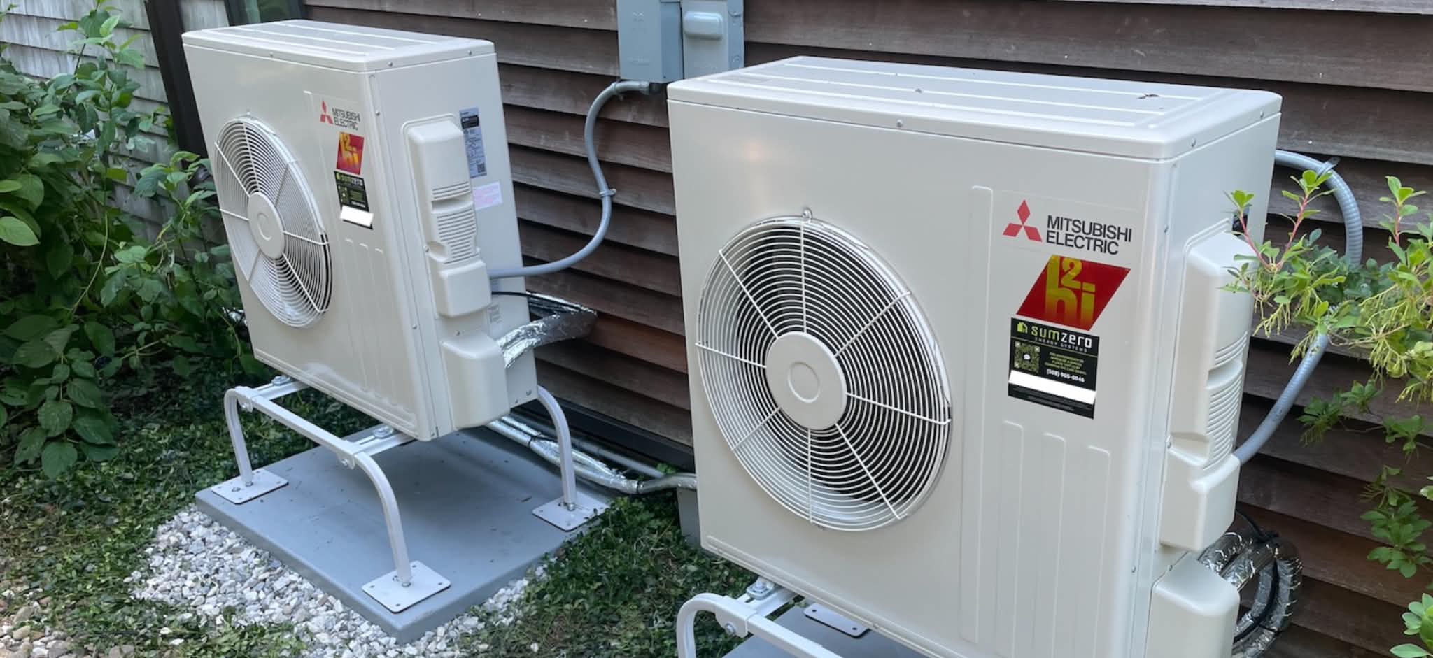 Mitsubishi Electric mini split outdoor units on mounting pads