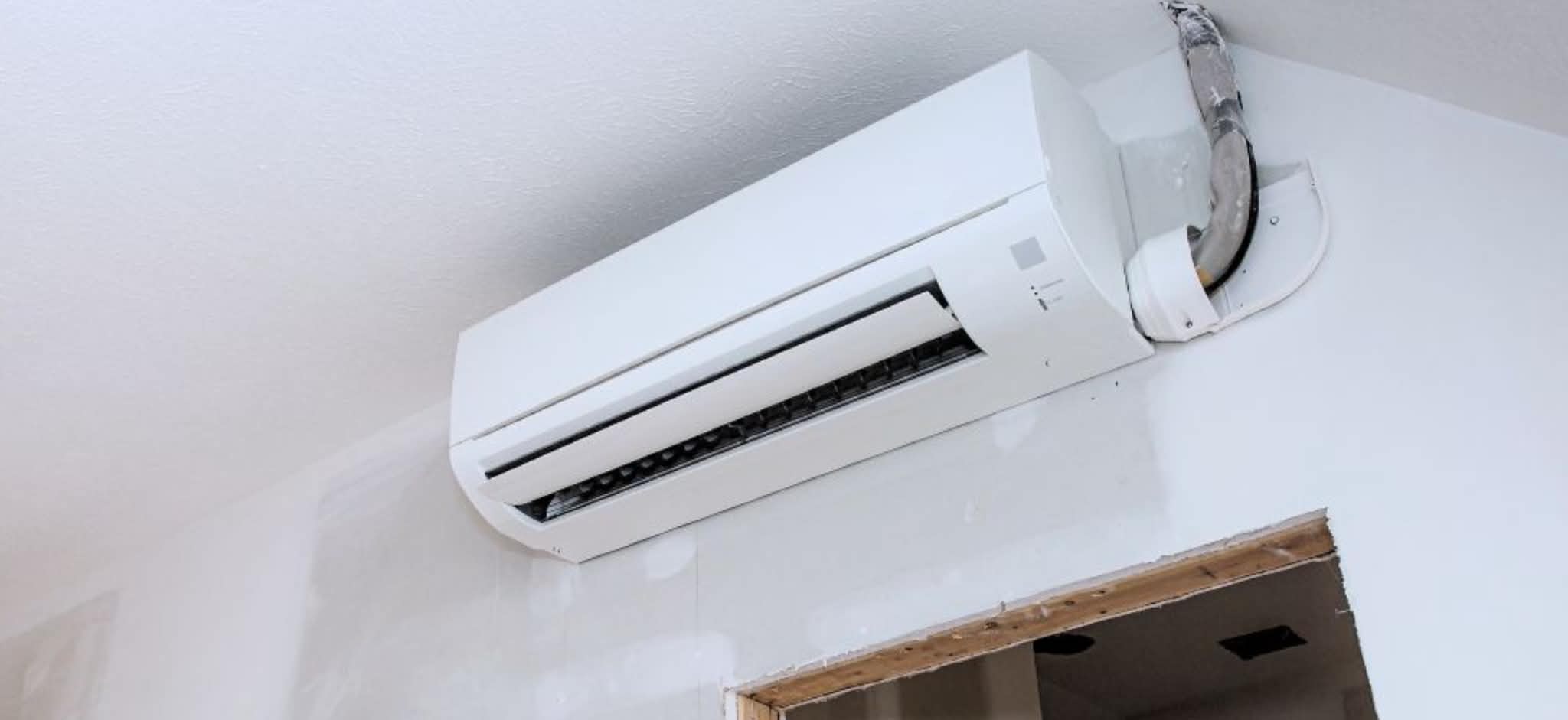 Indoor ductless mini split unit mounted on ceiling