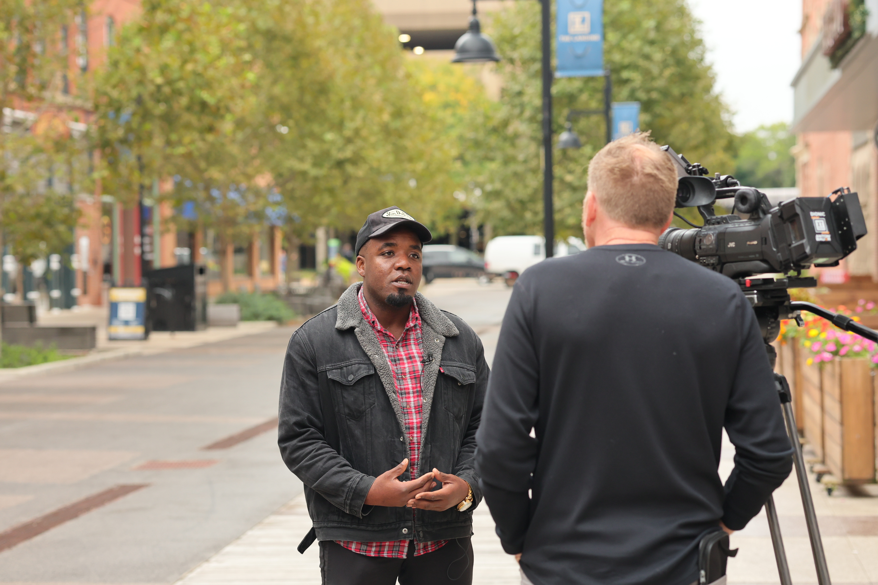 Victor Inwang speaking on camera during the 21Alive on-location interview on The Landing