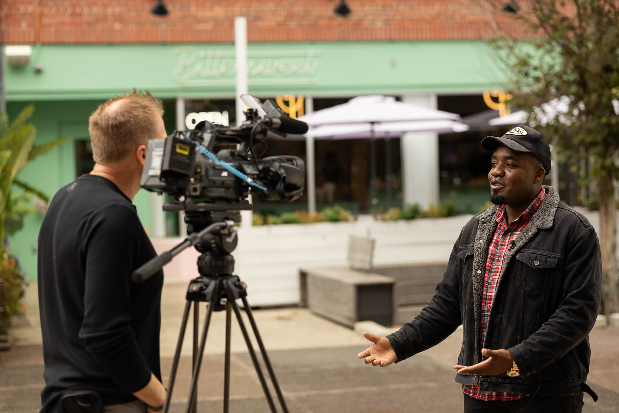 Wide shot of Victor Inwang speaking during the 21Alive interview at The Landing