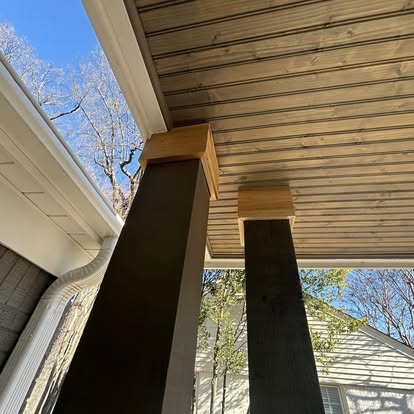 Craftsman tongue and groove wood porch ceiling with stained posts and cedar accent collars