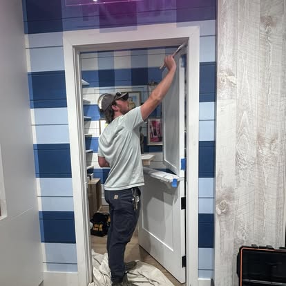 Carpenter installing door casing and precision commercial trim