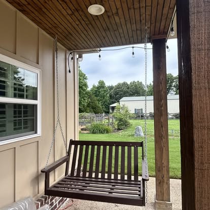 Tongue and groove porch ceiling with cedar posts, beam wrap, and suspended swing