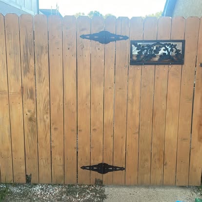 Wood privacy gate with decorative cast iron speakeasy grill window and ornamental strap hinges