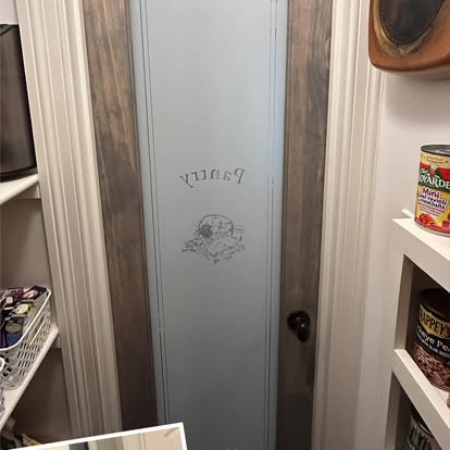 Custom etched glass pantry door with stained wood craftsman casing and moldings