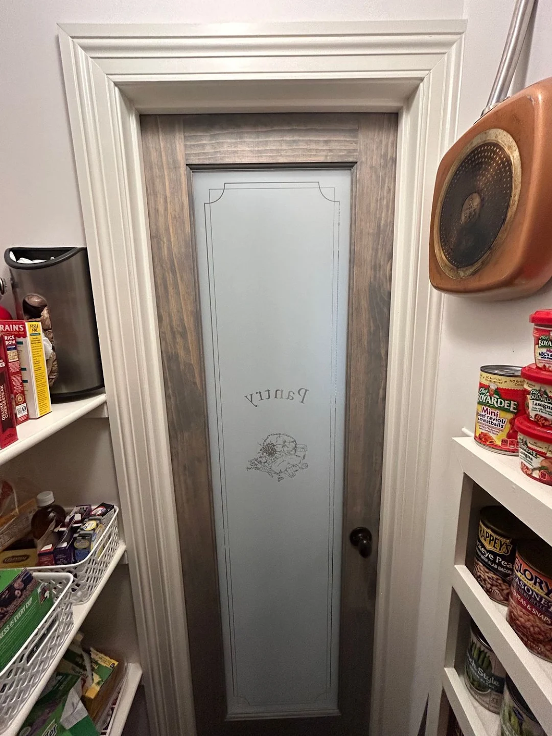 Custom etched glass pantry door with craftsman casing and header molding