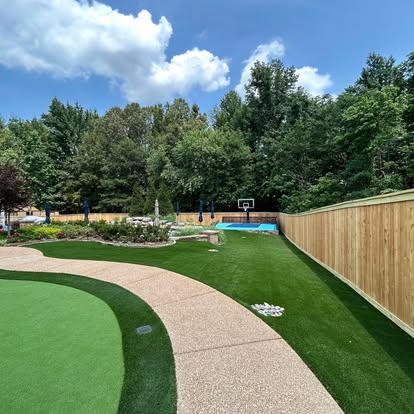Custom residential privacy fence enclosing turf lawn and sports court in Bartlett