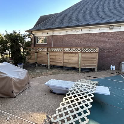 Custom wood privacy screen fence with lattice top panel around patio