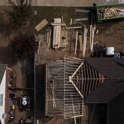 Aerial view of custom timber roof framing for covered deck and porch addition