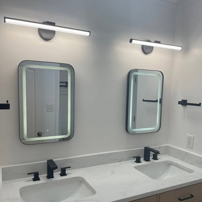 Luxury master bathroom remodel with dual modern LED vanity mirrors, quartz countertops, and matte black fixtures