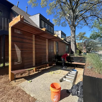 Modern exterior wood trellis, canopy, and integrated slatted bench