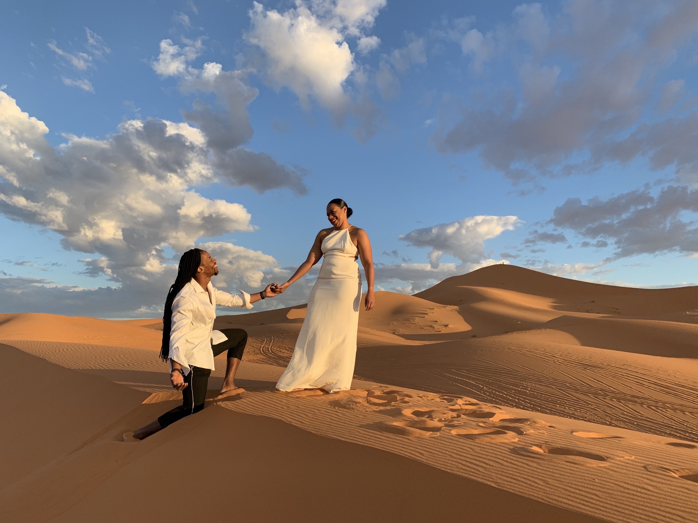 Kes and Jaz together in a wide desert landscape.