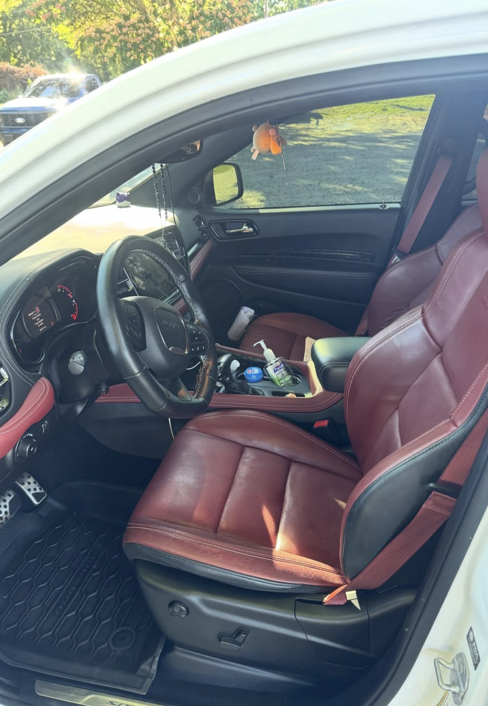 Immaculate Dodge Challenger SRT interior with clean red leather seats, detailed dashboard, and spotless floor mats after professional mobile detailing in Savannah