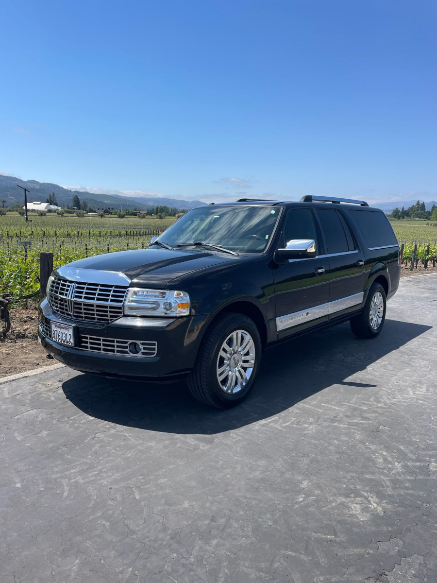 Joy and Buzz, owners of Napa Wine Tours By Joy, with their vehicle