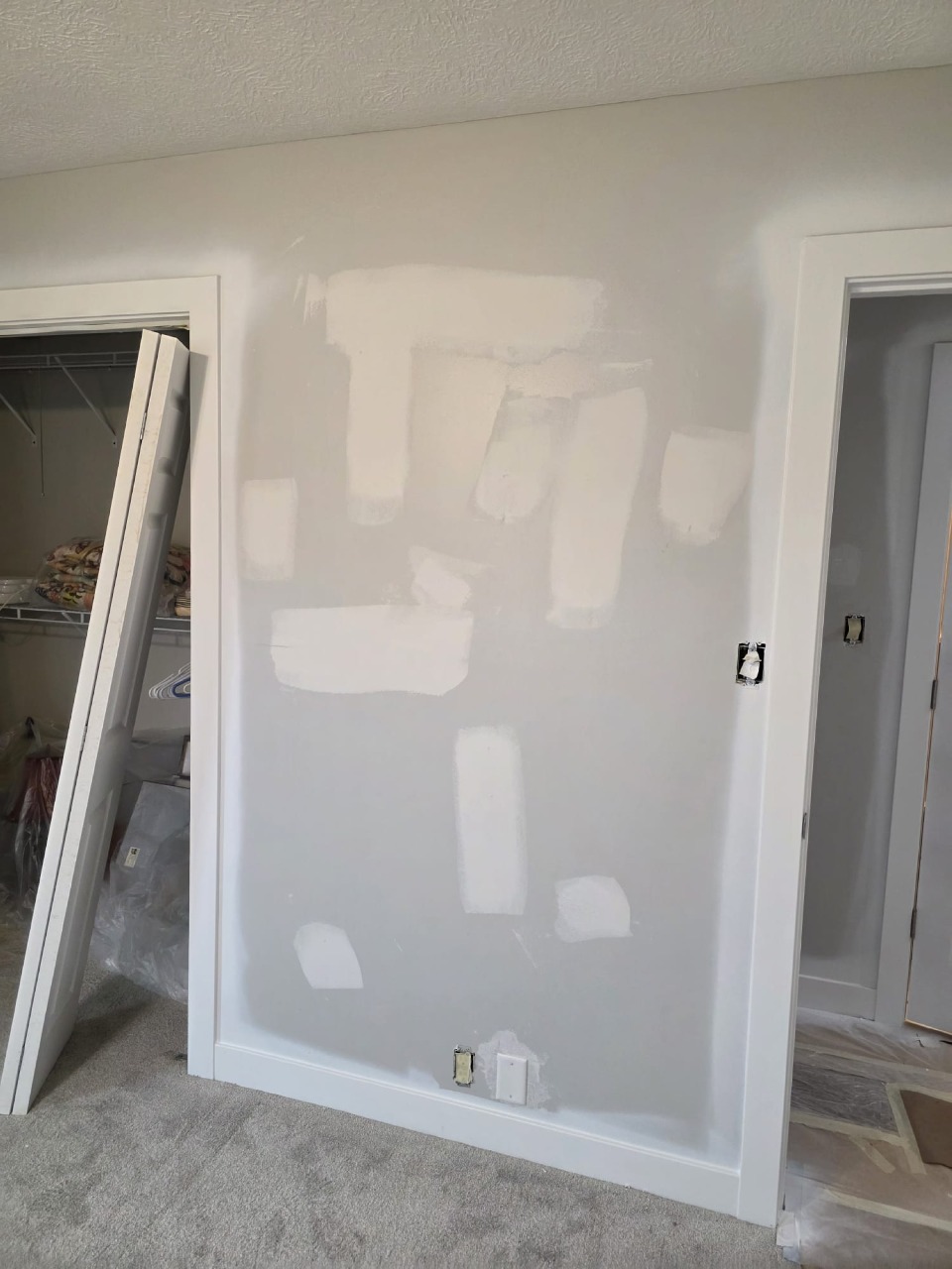 Interior wall with professional drywall patching and spackling preparation before painting