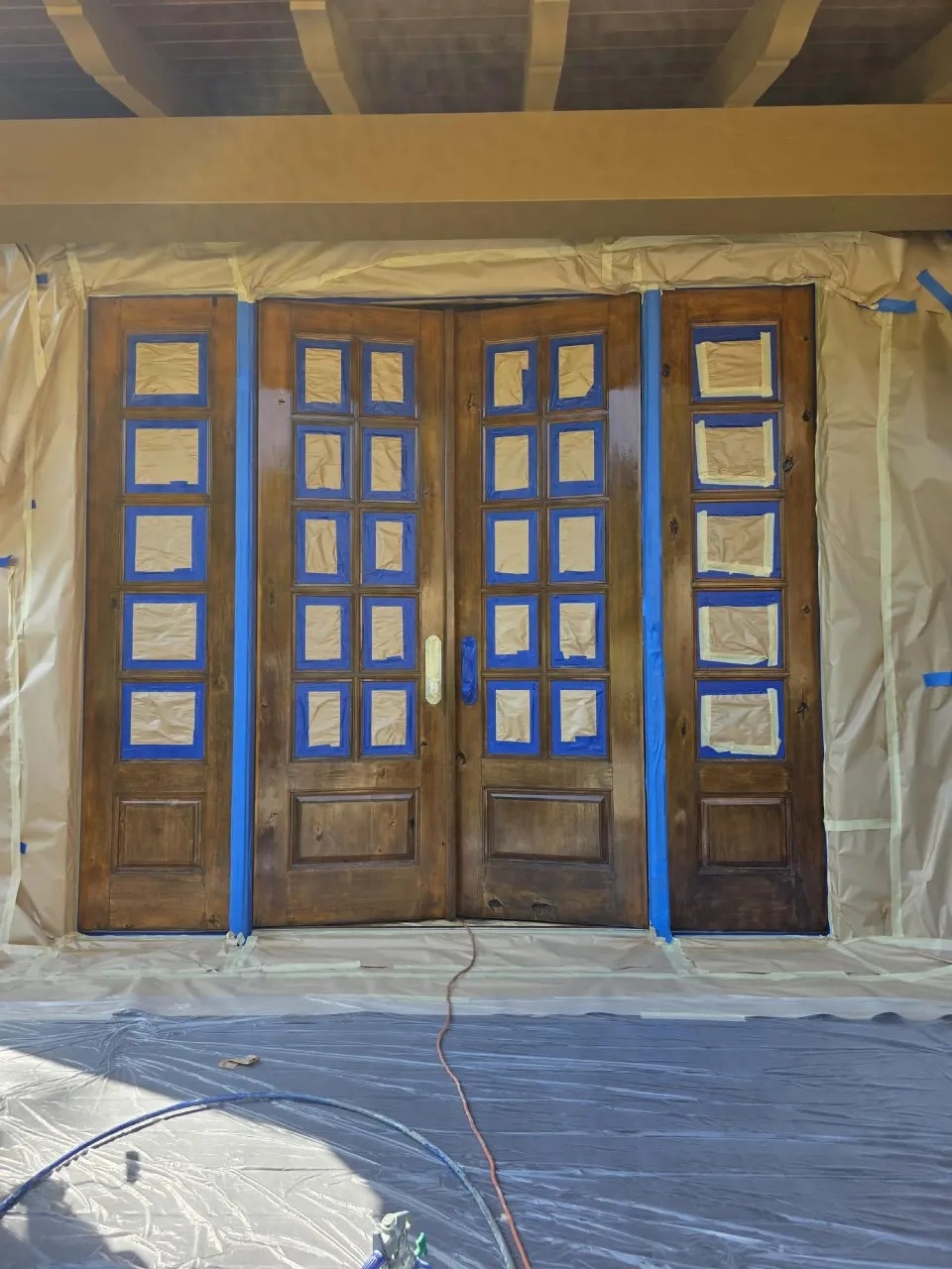French doors masked with tape and paper for professional painting