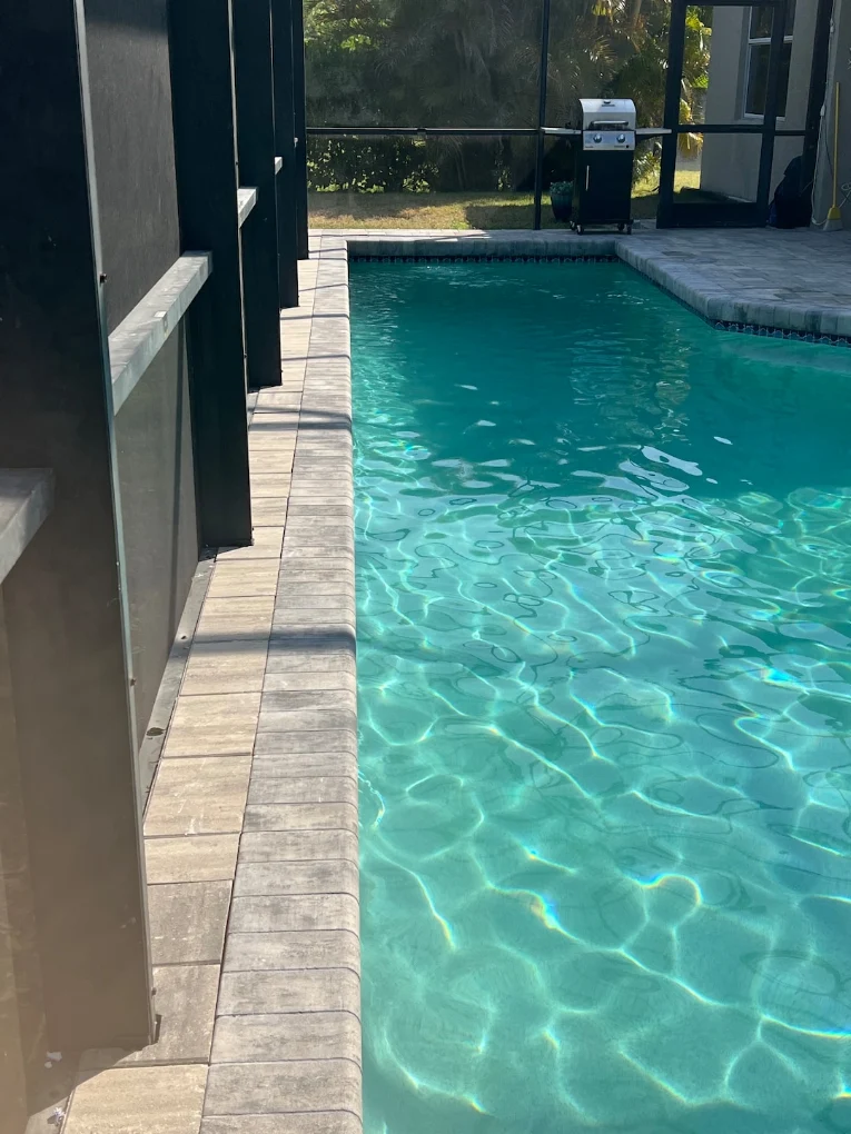 Contemporary pool edge paver installation with clean lines and modern coping