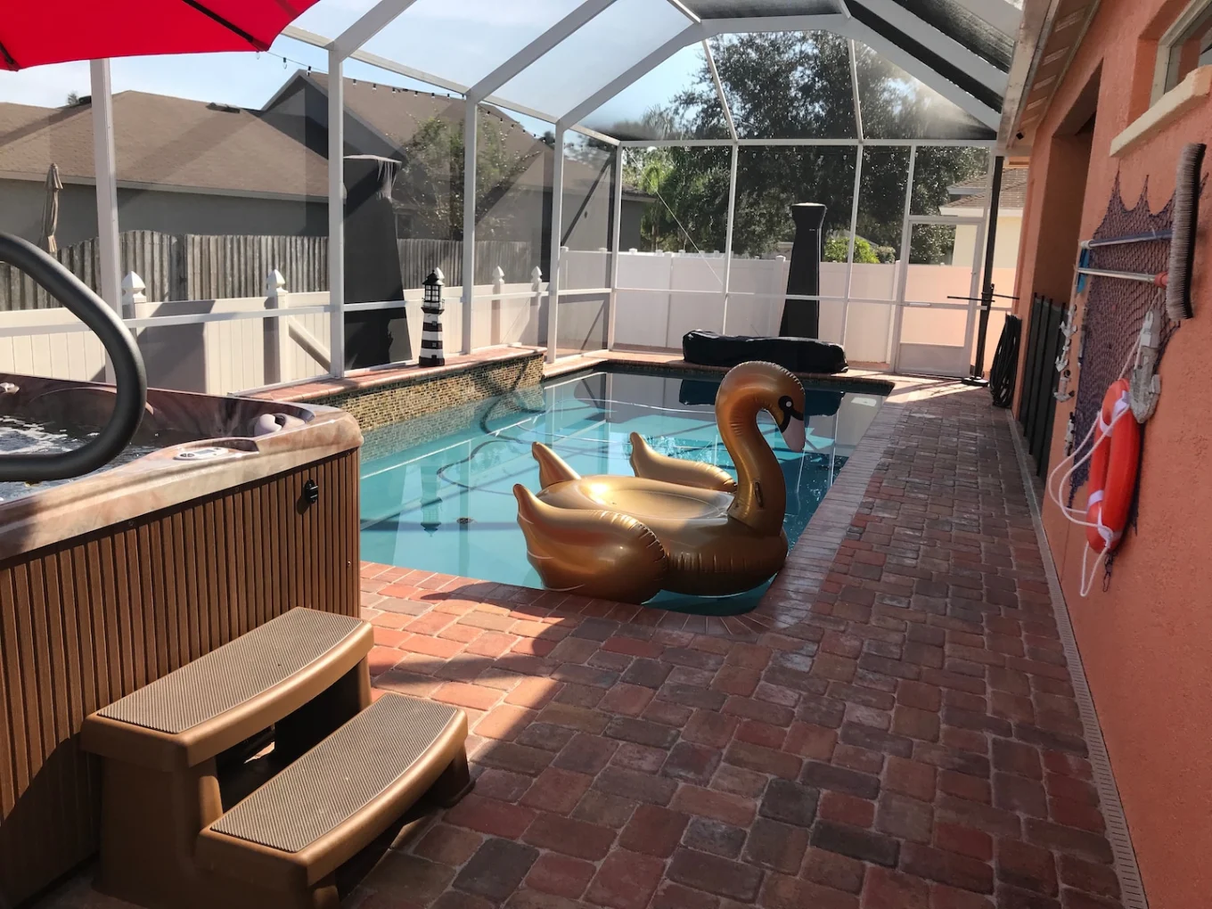 Pool deck paver installation with hot tub and screened enclosure in Sarasota