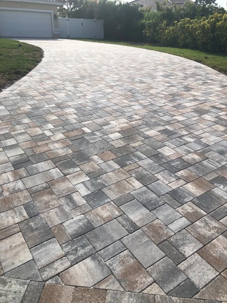 Curved multi-tone paver driveway with varied earth-tone color pattern