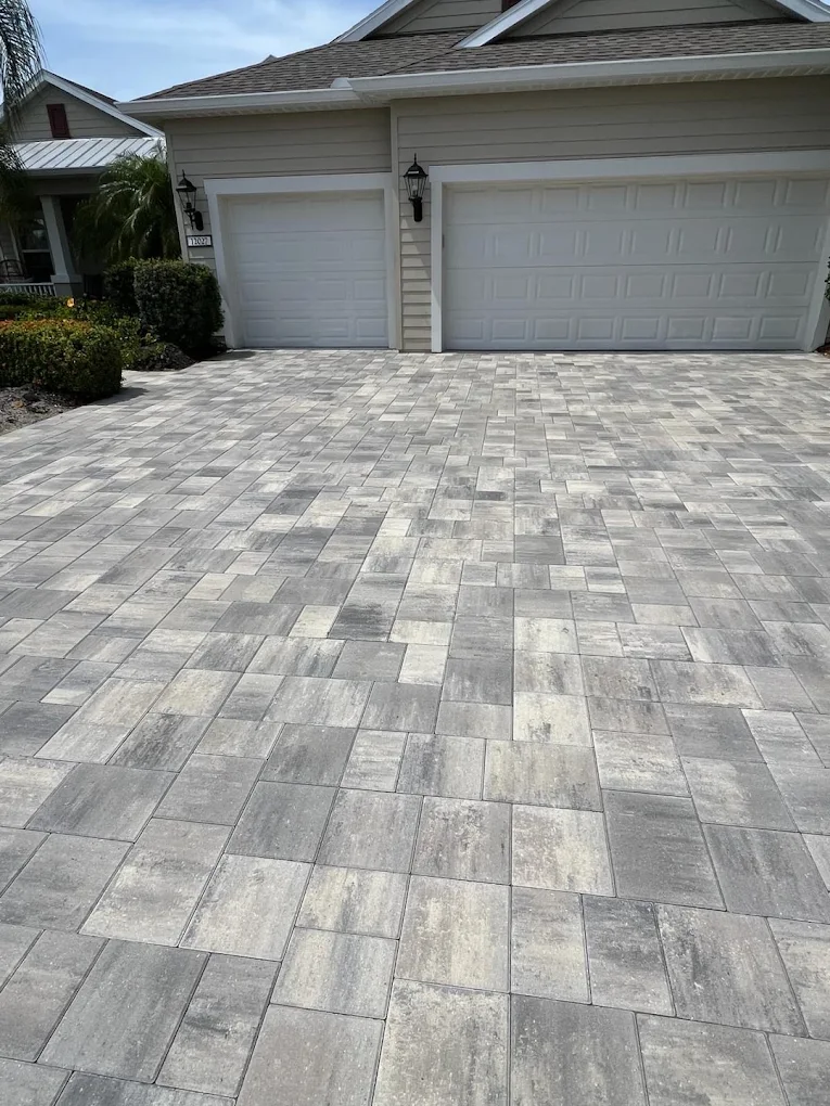 Detailed herringbone paver driveway pattern in gray tones