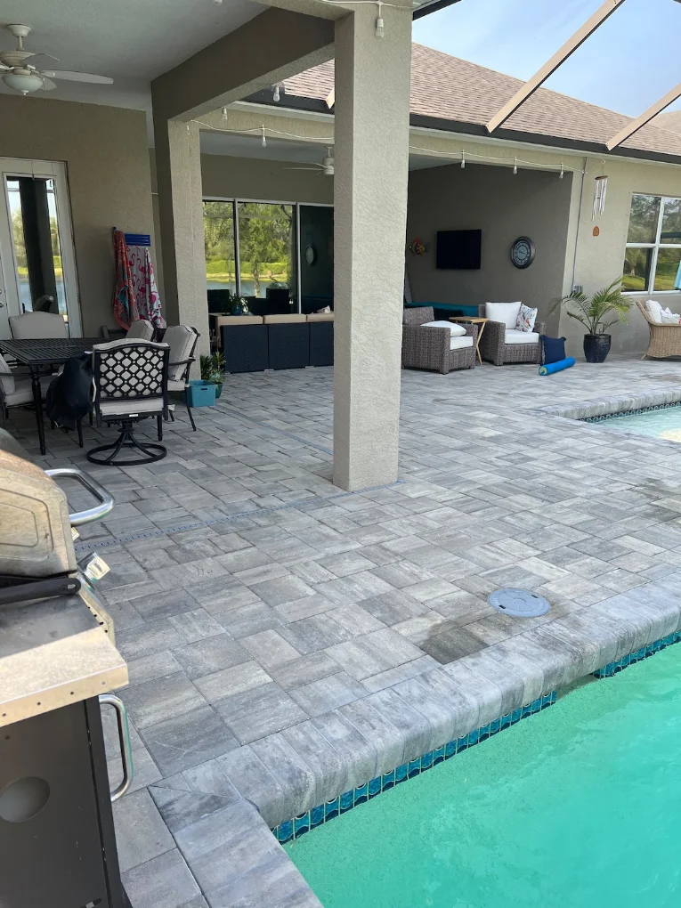 Pool deck and lanai paver installation with screened enclosure