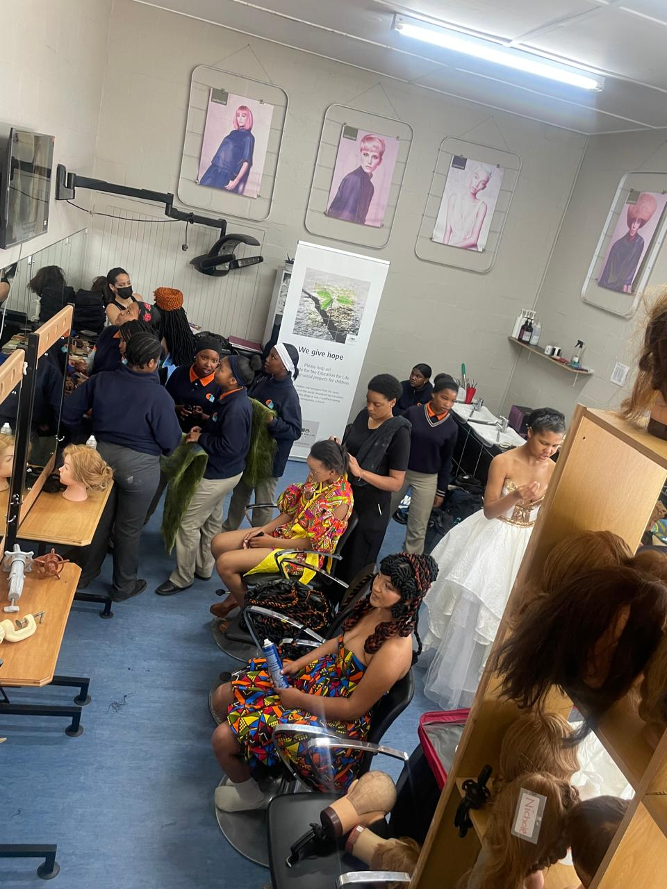 Students learning hairdressing techniques in the Christel House salon classroom