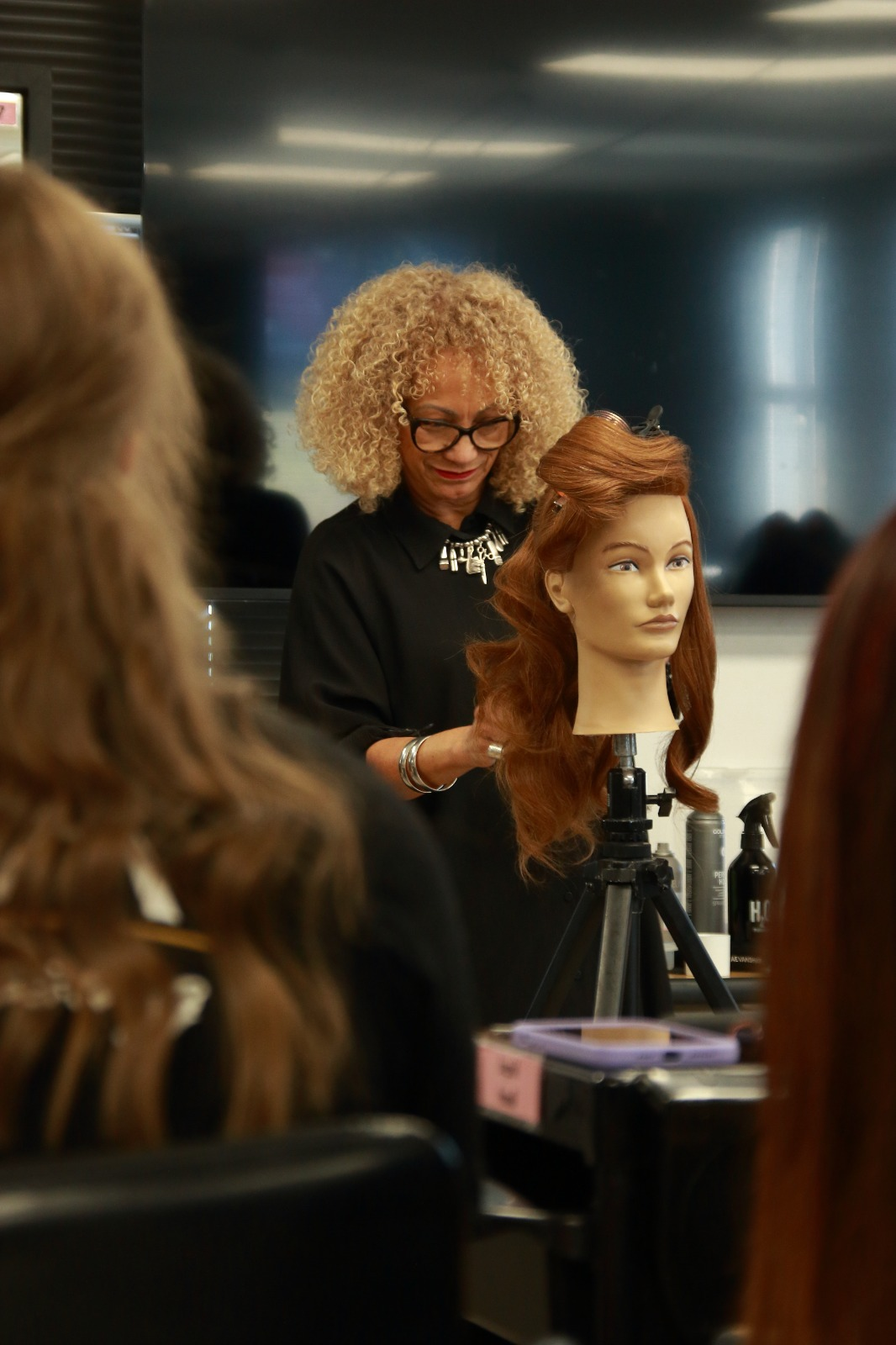 Ezra Isaacs teaching hairdressing techniques