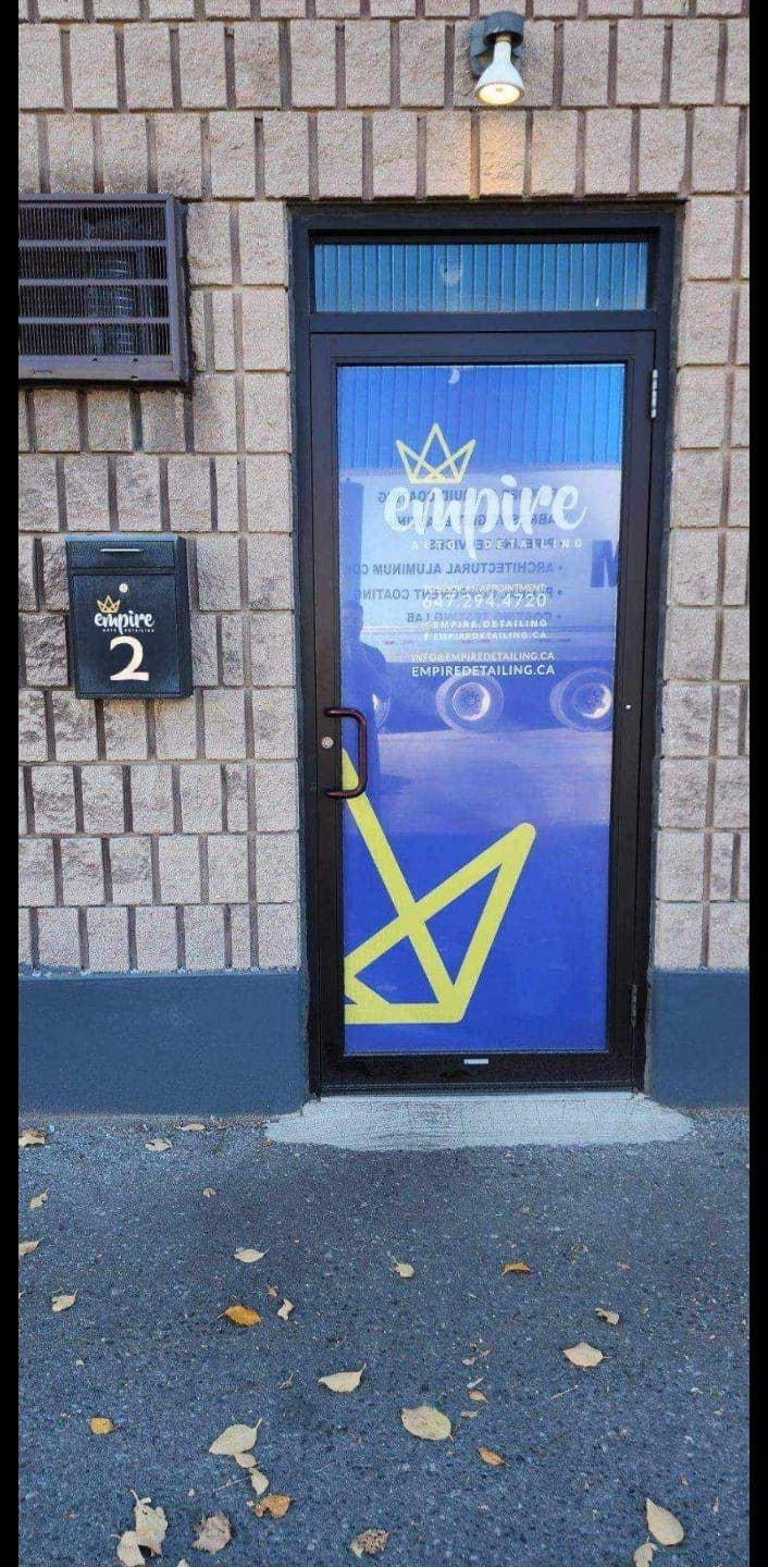 Empire Auto Detailing storefront entrance with branded door and signage
