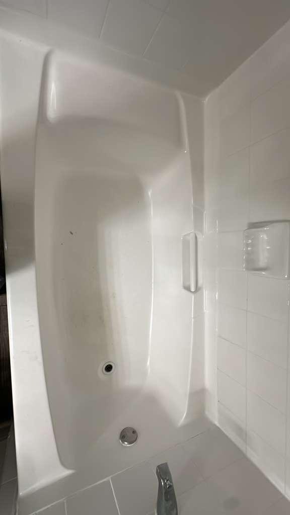 Newly installed bathtub with white tile surround by Paint And Remodeling Aguilar LLC