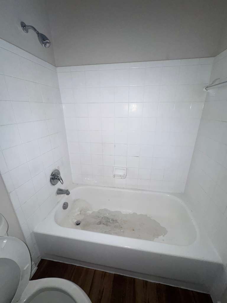 Bathroom before deep cleaning - dirty bathtub with stains and grime by Paint And Remodeling Aguilar LLC