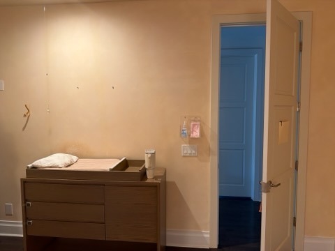 Nursery room with freshly painted beige walls and modern dresser by Paint And Remodeling Aguilar