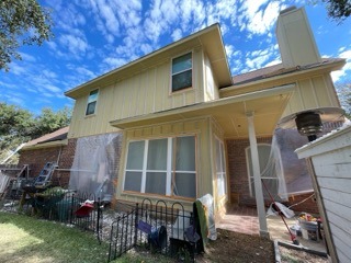 Home undergoing exterior renovation with new tan siding in Pflugerville Texas