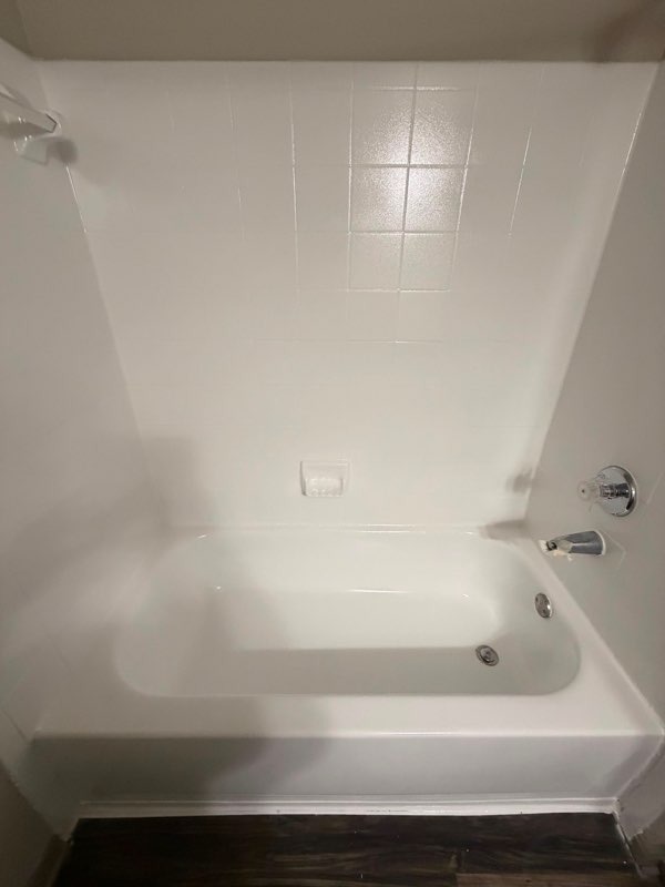 Refinished white shower and bathtub with clean tile surround in Bastrop TX
