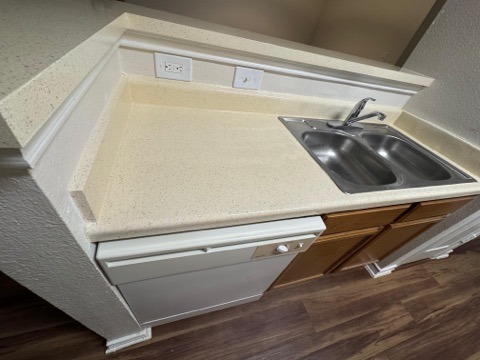 Updated kitchen with speckled countertop and wooden cabinets by Paint And Remodeling Aguilar