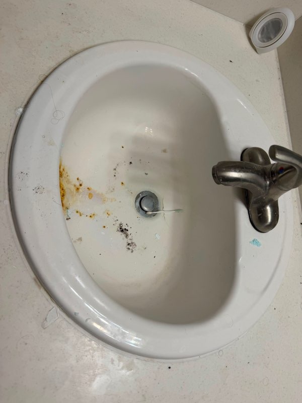 Restored white bathroom sink with new faucet by Paint And Remodeling Aguilar LLC