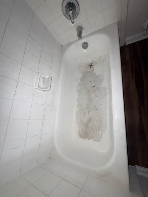 Bathtub before refinishing - dirty worn surface with stains and grime by Paint And Remodeling Aguilar LLC