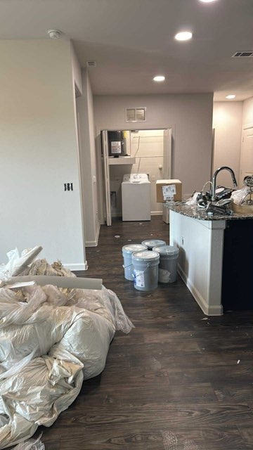 Kitchen before remodeling - construction debris, paint buckets and unfinished surfaces by Paint And Remodeling Aguilar LLC