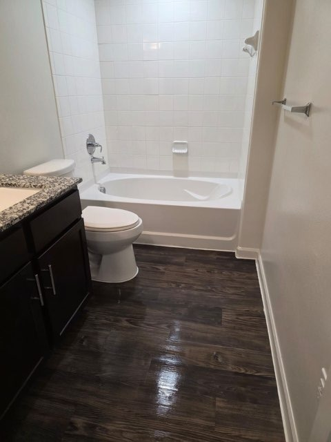 Bathroom after complete vanity remodel - dark espresso cabinets with granite countertop, dark wood flooring and premium fixtures by Paint And Remodeling Aguilar LLC