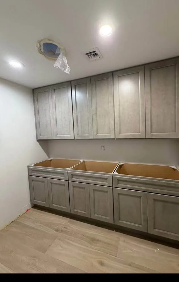 Gray stained kitchen cabinet refinishing with modern smooth finish