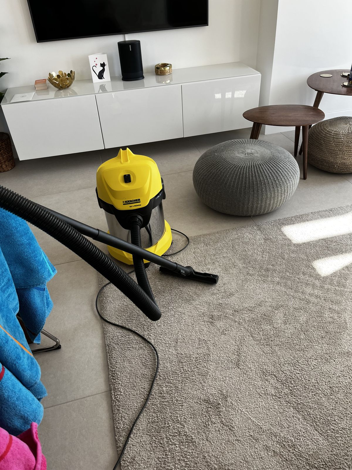 Residential home cleaning with yellow vacuum cleaner on clean carpet