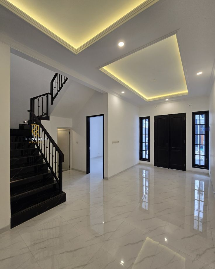Luxury entryway with marble floors black staircase and modern lighting