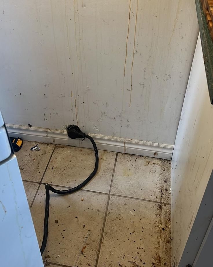 Dirty kitchen wall and floor before deep cleaning service