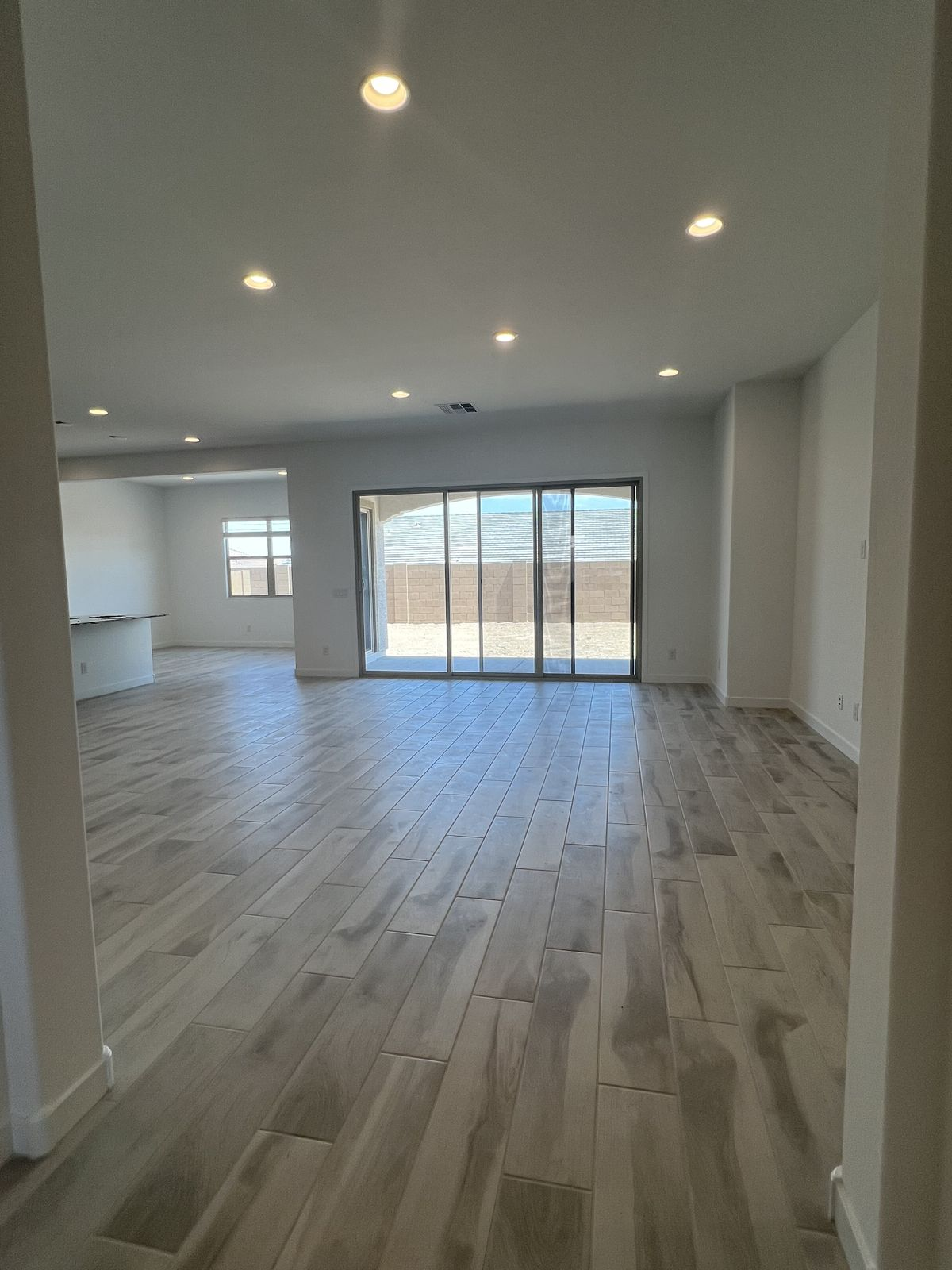 Spotless empty home interior with light wood tile flooring after move-in cleaning
