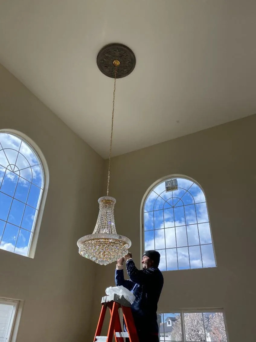 High-Ceiling Crystal Chandelier Install in Luxury Custom Home with Arched Windows — Granite Bay