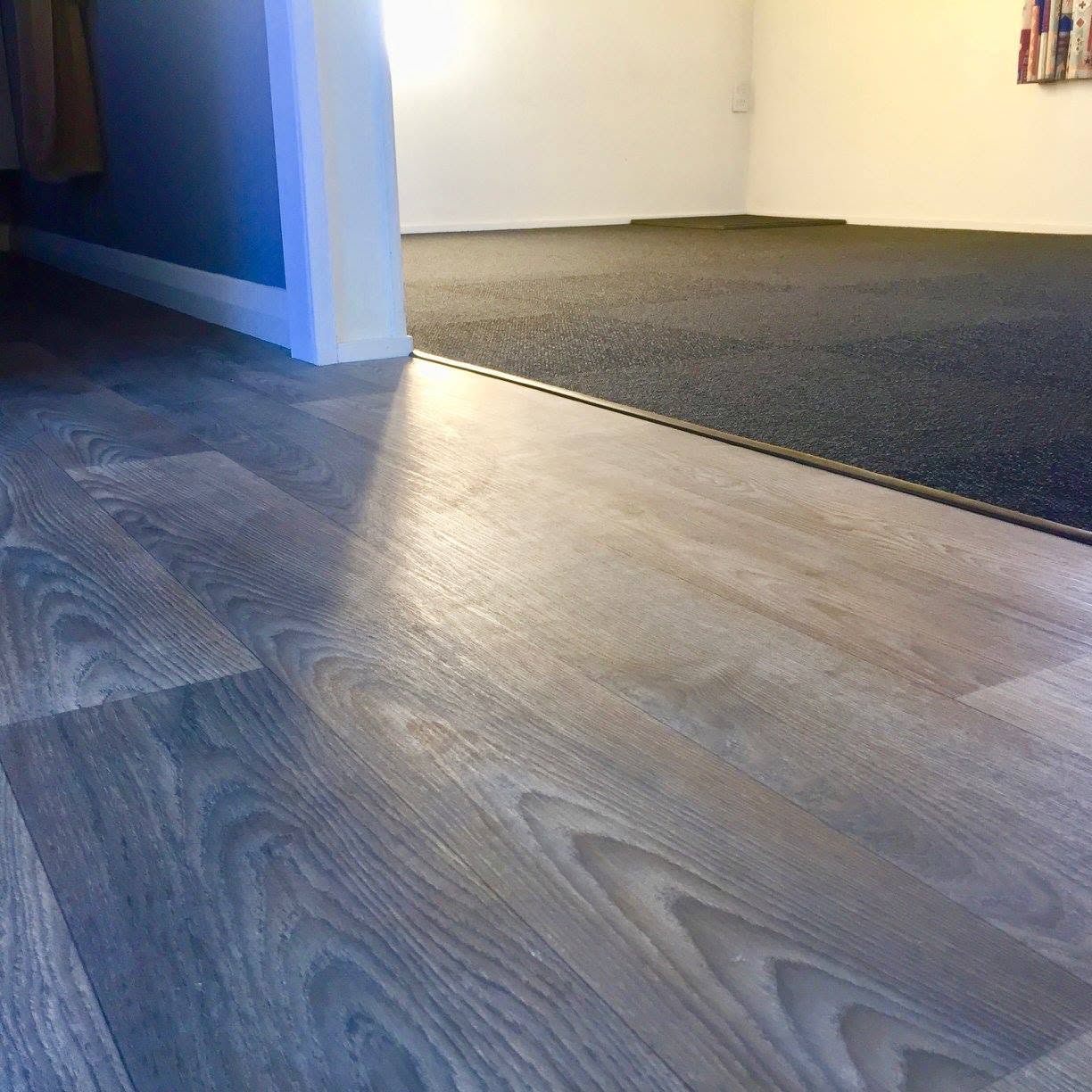 Close-up of timber-look vinyl plank flooring with detailed wood grain installed by The Flooring Place