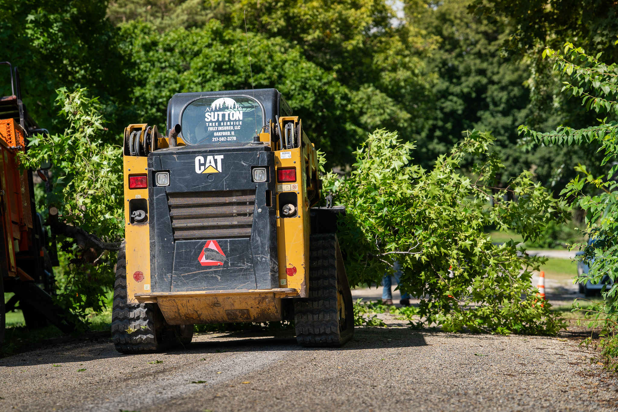 Sutton CAT skid steer moving storm debris after cleanup in Havana Illinois