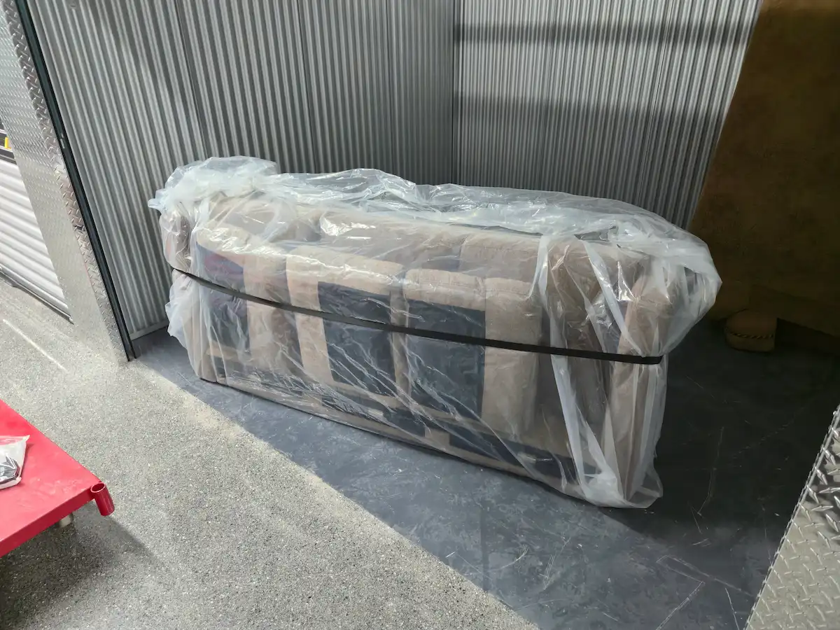 Job-Haul movers padding and wrapping a grand piano with moving blankets and straps in a Vaughan home