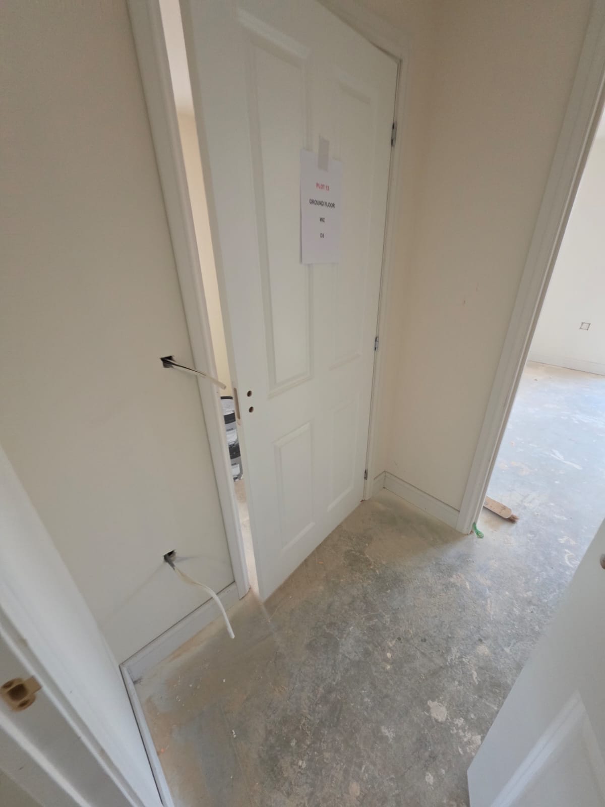 Plot 13 ground floor WC door D1 hung with signage and architrave in Harlow development by DWELLUX