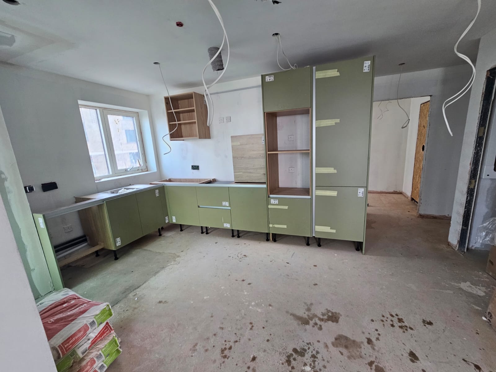 Kitchen unit assembly, appliance housing and floor preparation in progress in Southend-on-Sea property by DWELLUX