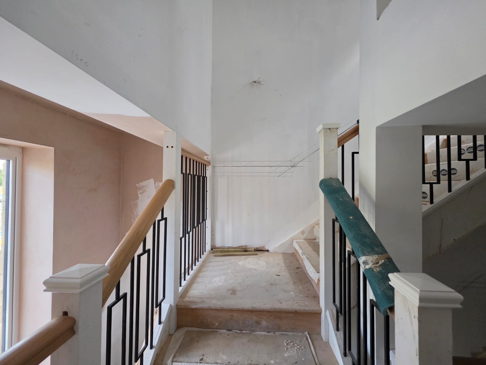 Stairwell geometric black metal and timber balustrades with solid oak handrail in Southend-on-Sea by DWELLUX